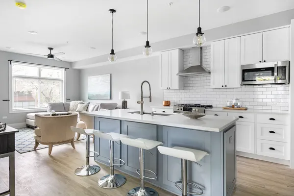 a kitchen with granite countertop a sink appliances and cabinets
