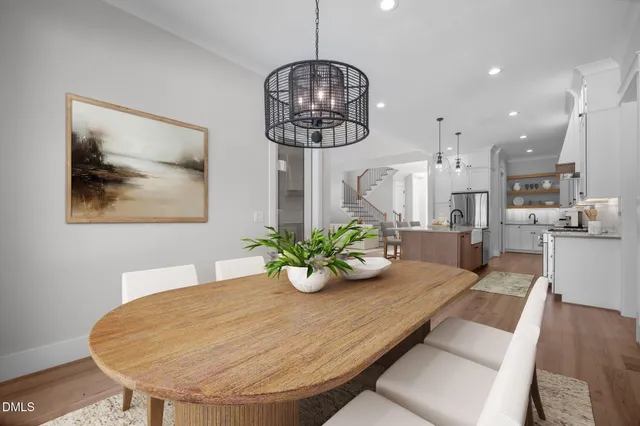a view of an empty room with wooden floor fireplace and a window