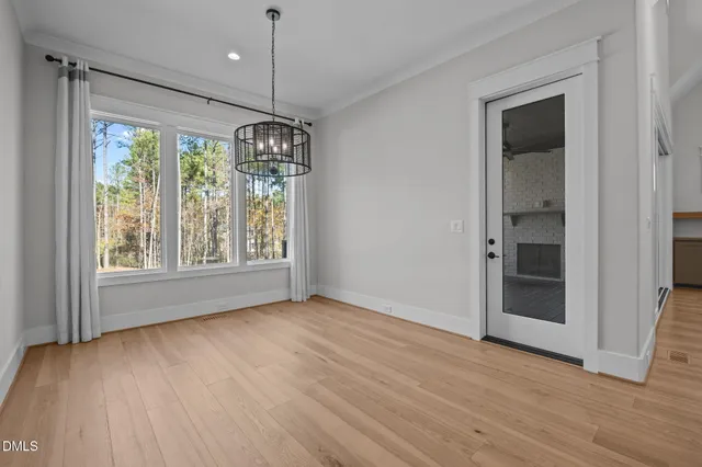 a view of kitchen with wooden floor and electronic appliances