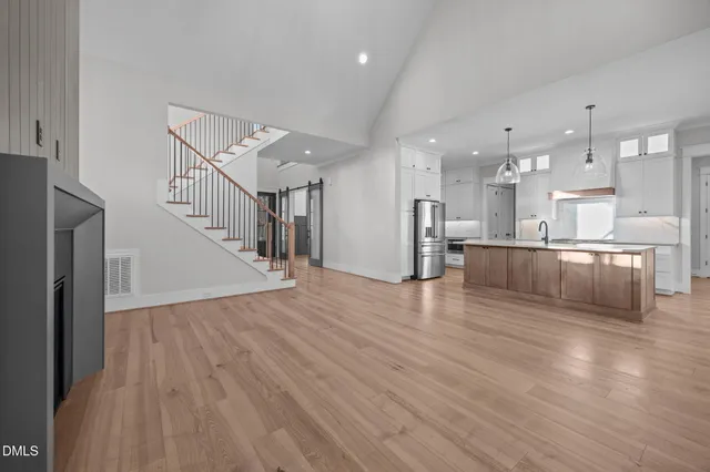 a spacious bathroom with a granite countertop double vanity sink and a mirror