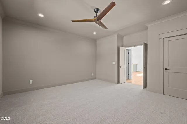 an empty room with a ceiling fan and a window