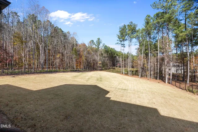 a large kitchen with cabinets wooden floor and stainless steel appliances