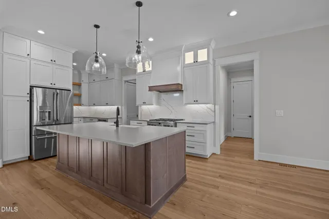 a view of a dining room with furniture wooden floor and chandelier