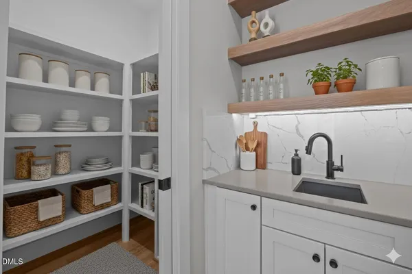 a spacious bedroom with a bed a dresser and window