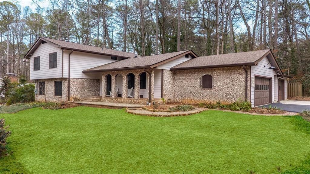 a front view of a house with yard and balcony