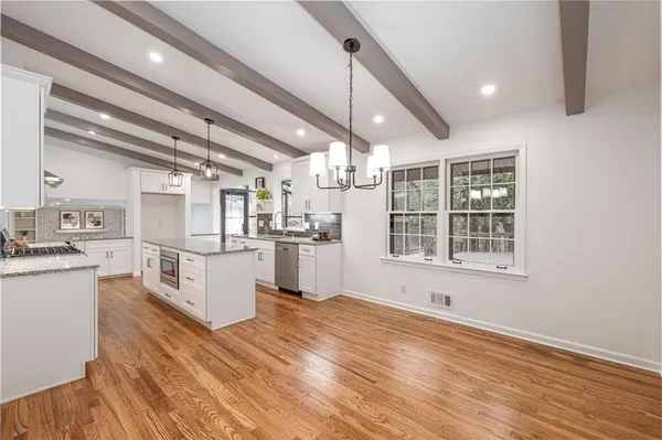 view of living room with a large window and pool