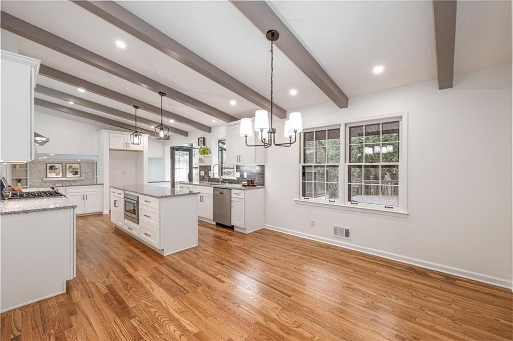 5087 Antelope Lane Smoke Rise, GA 30087 - Photo 14 of 56 a kitchen with granite countertop a stove and a sink