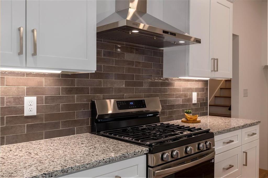 5087 Antelope Lane Smoke Rise, GA 30087 - Photo 16 of 56 a stove top oven sitting inside of a kitchen