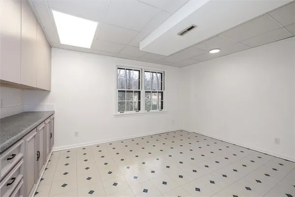 a front view of a house with a yard covered in snow