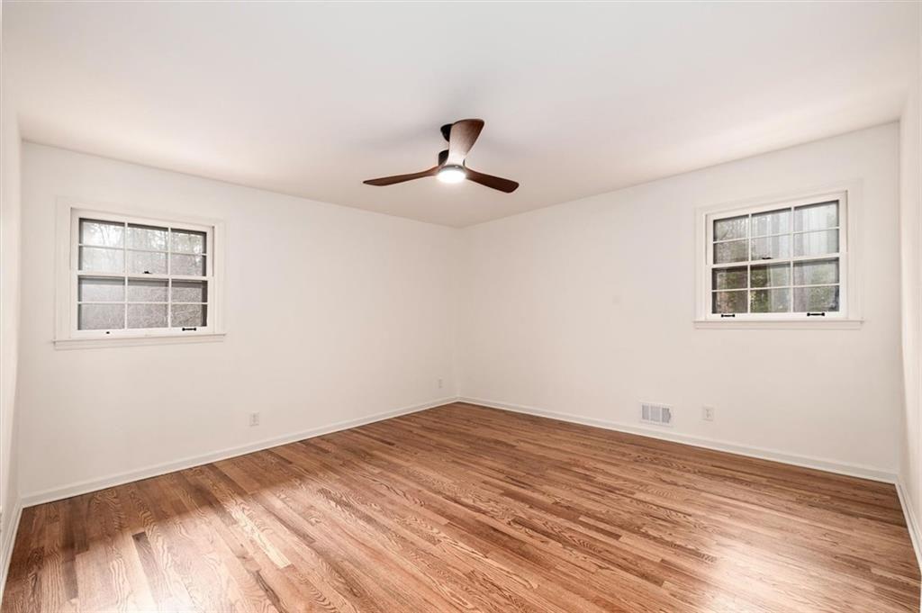5087 Antelope Lane Smoke Rise, GA 30087 - Photo 40 of 56 a view of empty room with wooden floor and fan