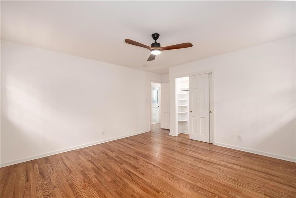 5087 Antelope Lane Smoke Rise, GA 30087 - Photo 41 of 56 an empty room with wooden floor and windows
