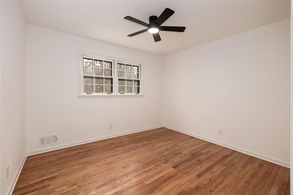 5087 Antelope Lane Smoke Rise, GA 30087 - Photo 43 of 56 a view of empty room with wooden floor and fan