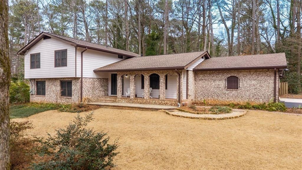 5087 Antelope Lane Smoke Rise, GA 30087 - Photo 6 of 56 a front view of a house with a yard and garage
