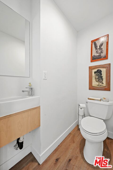 6926 Cedros Avenue Van Nuys, CA 91405 - Photo 13 of 26 a white toilet sitting next to a bathroom sink