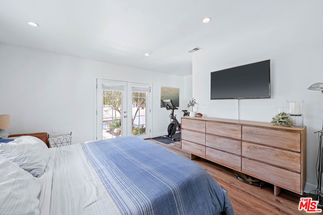 6926 Cedros Avenue Van Nuys, CA 91405 - Photo 14 of 26 a bedroom with a bed and a flat screen tv