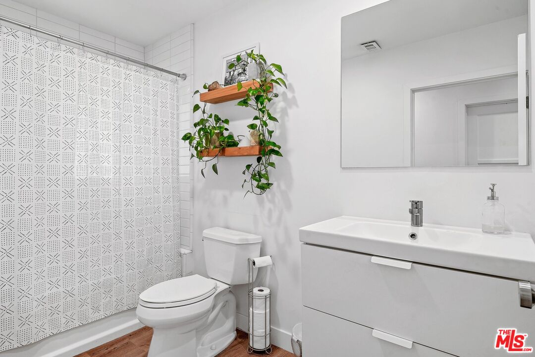 6926 Cedros Avenue Van Nuys, CA 91405 - Photo 18 of 26 a bathroom with a sink a toilet and a mirror