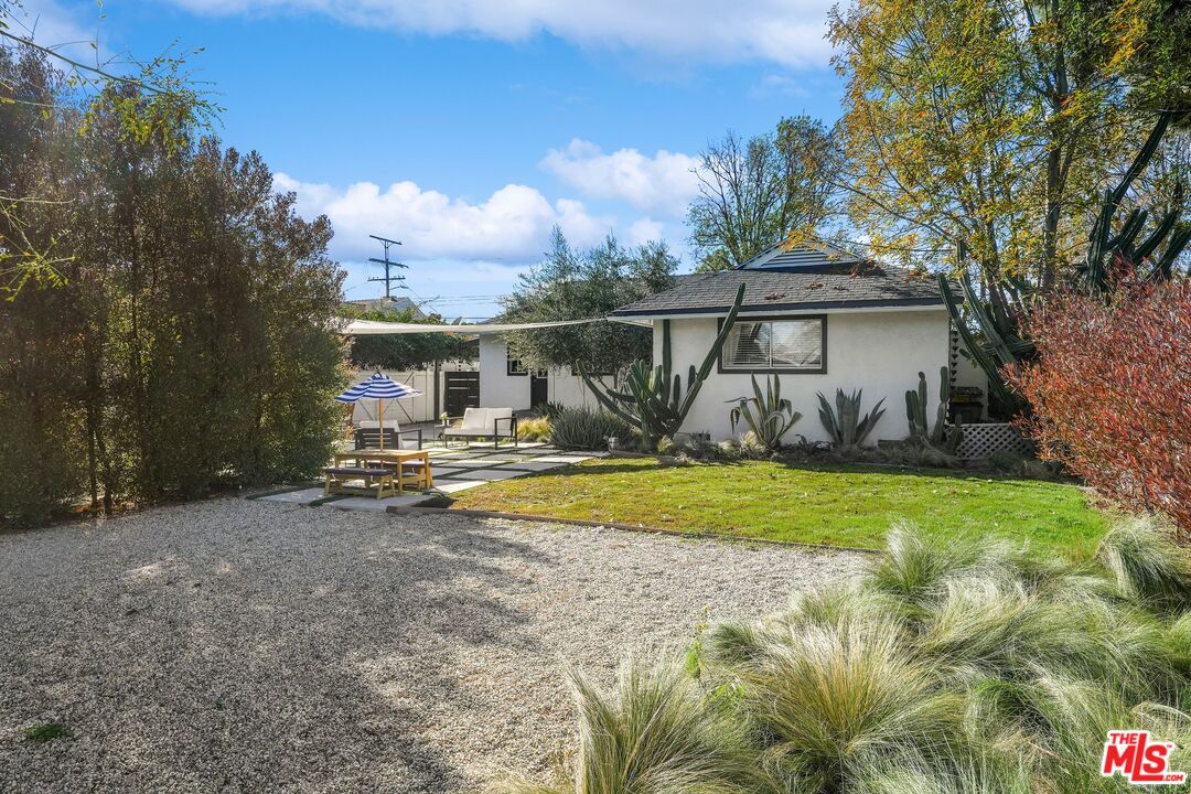 6926 Cedros Avenue Van Nuys, CA 91405 - Photo 20 of 26 a view of a house with backyard and a tree