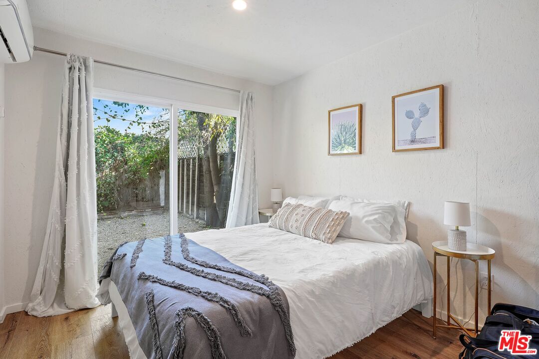 6926 Cedros Avenue Van Nuys, CA 91405 - Photo 21 of 26 a bedroom with a bed and a large window