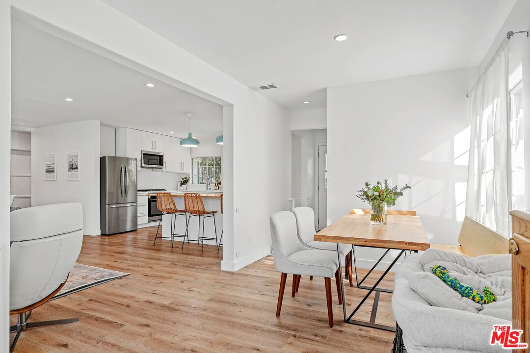 6926 Cedros Avenue Van Nuys, CA 91405 - Photo 10 of 26 a living room with furniture and a dining table with kitchen view