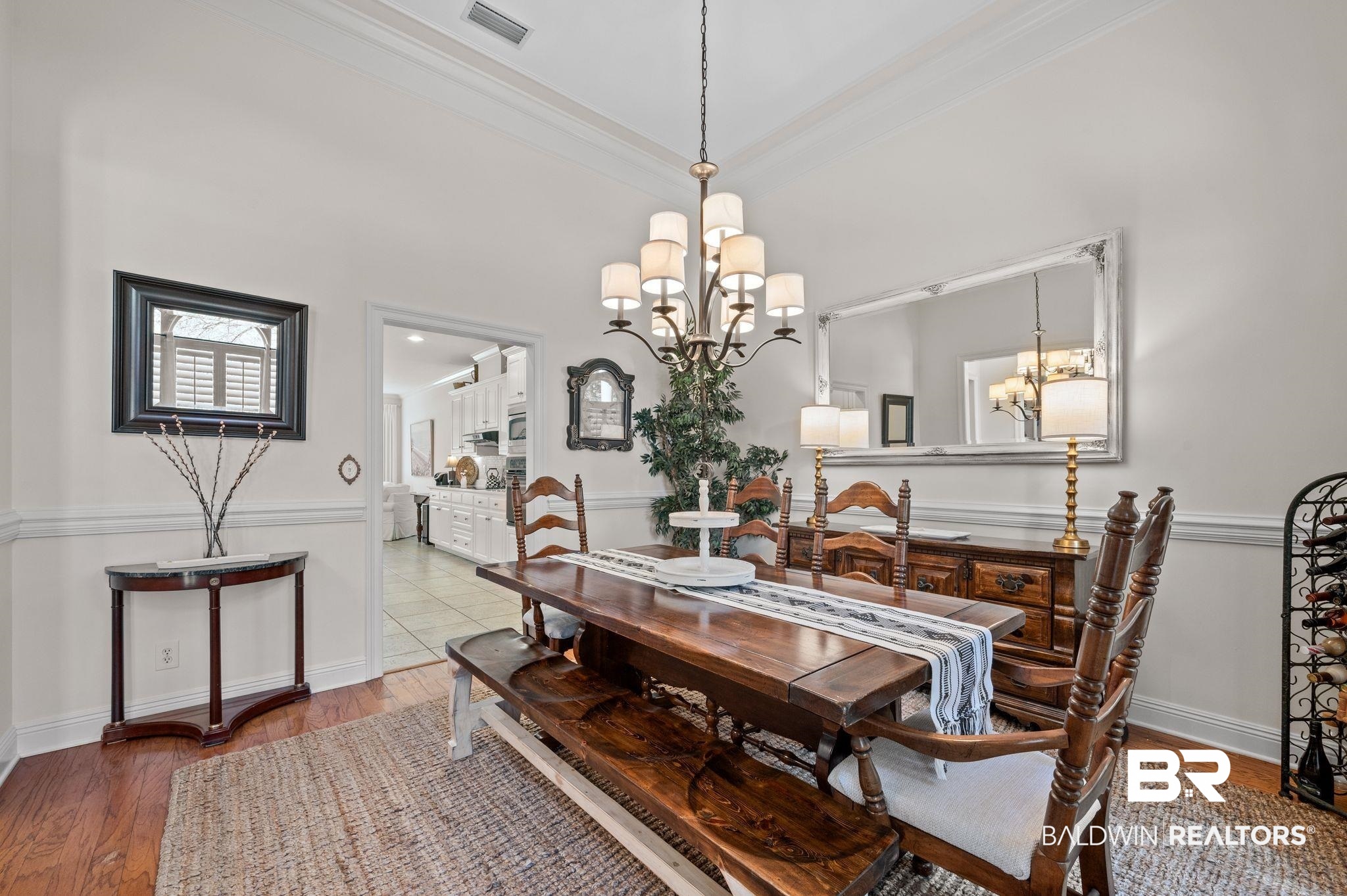 30151 Dolive Ridge Daphne, AL 36527 - Photo 8 of 37 Dining room featuring visible vents, baseboards, ornamental molding, an inviting chandelier, and wood finished floors