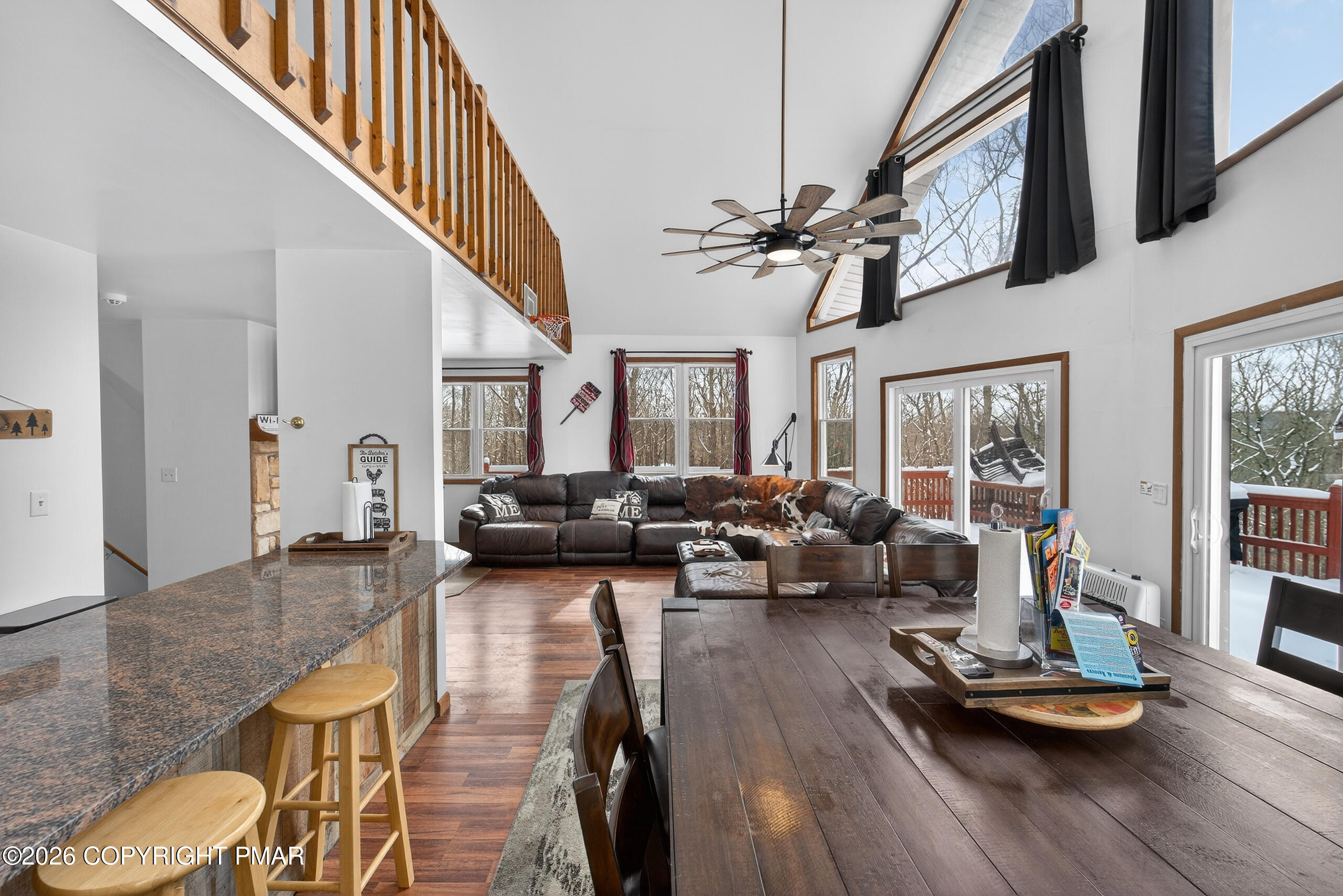 3112 Spring Court Bushkill, PA 18324 - Photo 16 of 52 a living room with furniture kitchen view and a wooden floor