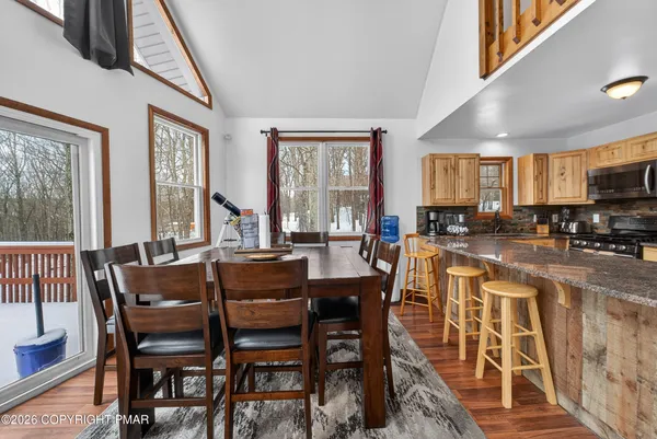 a view of a dining room with furniture window and outside view