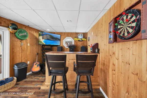 a view of a room with furniture and wooden floor