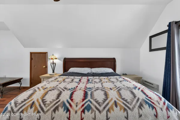 a bedroom with furniture and wooden floor