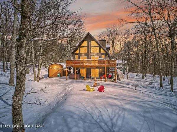 a view of a house with a backyard and a tree