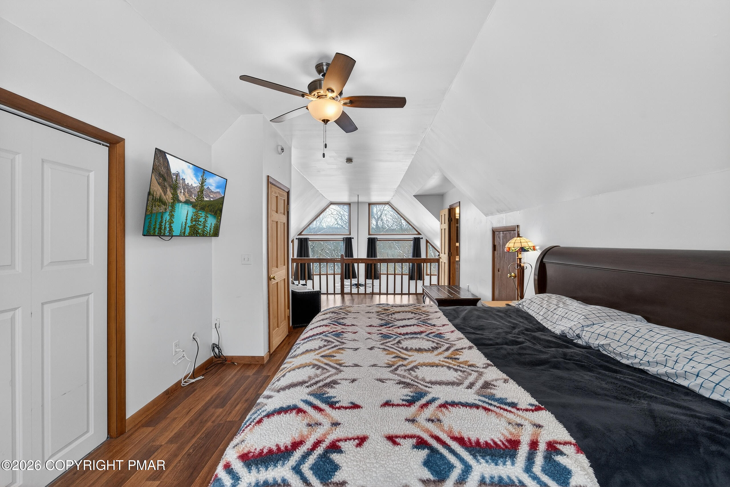 3112 Spring Court Bushkill, PA 18324 - Photo 34 of 52 a bedroom with a large bed and a chandelier