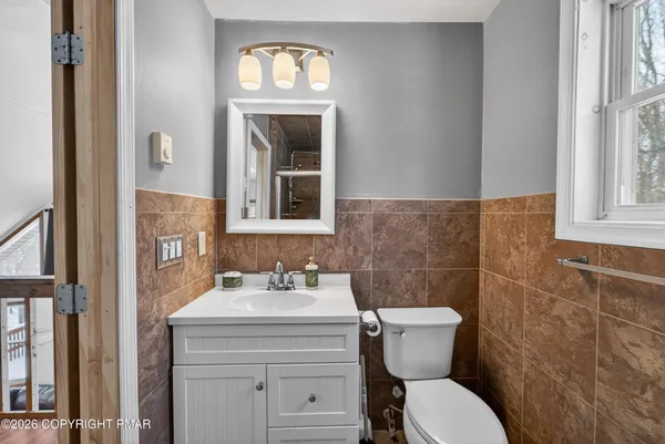 a bathroom with a sink toilet and mirror