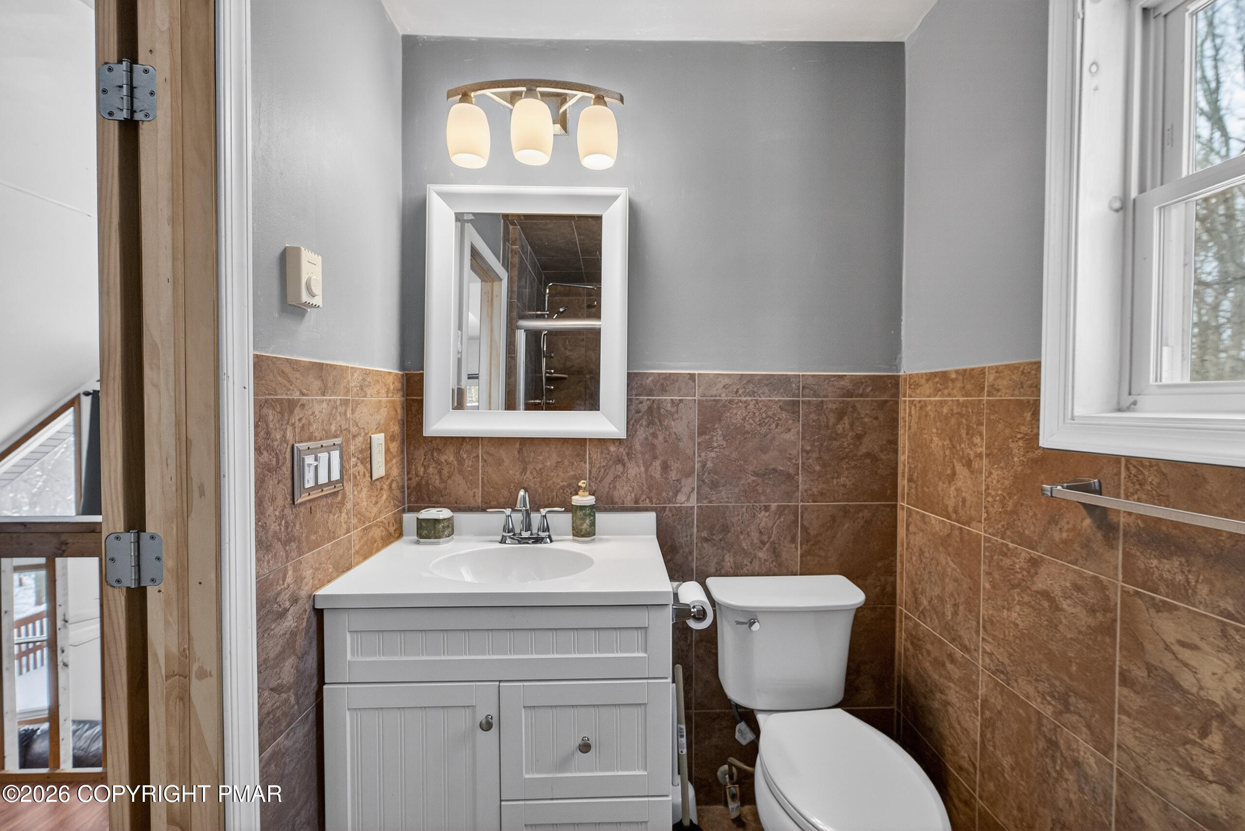 3112 Spring Court Bushkill, PA 18324 - Photo 36 of 52 a bathroom with a toilet sink and mirror