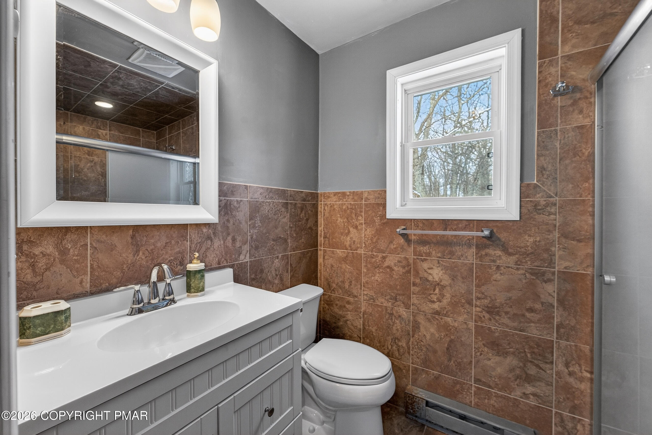 3112 Spring Court Bushkill, PA 18324 - Photo 37 of 52 a bathroom with a sink toilet and mirror