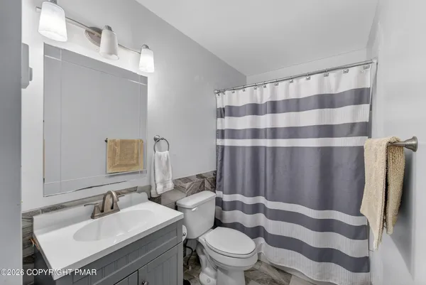 a bathroom with a sink toilet and shower