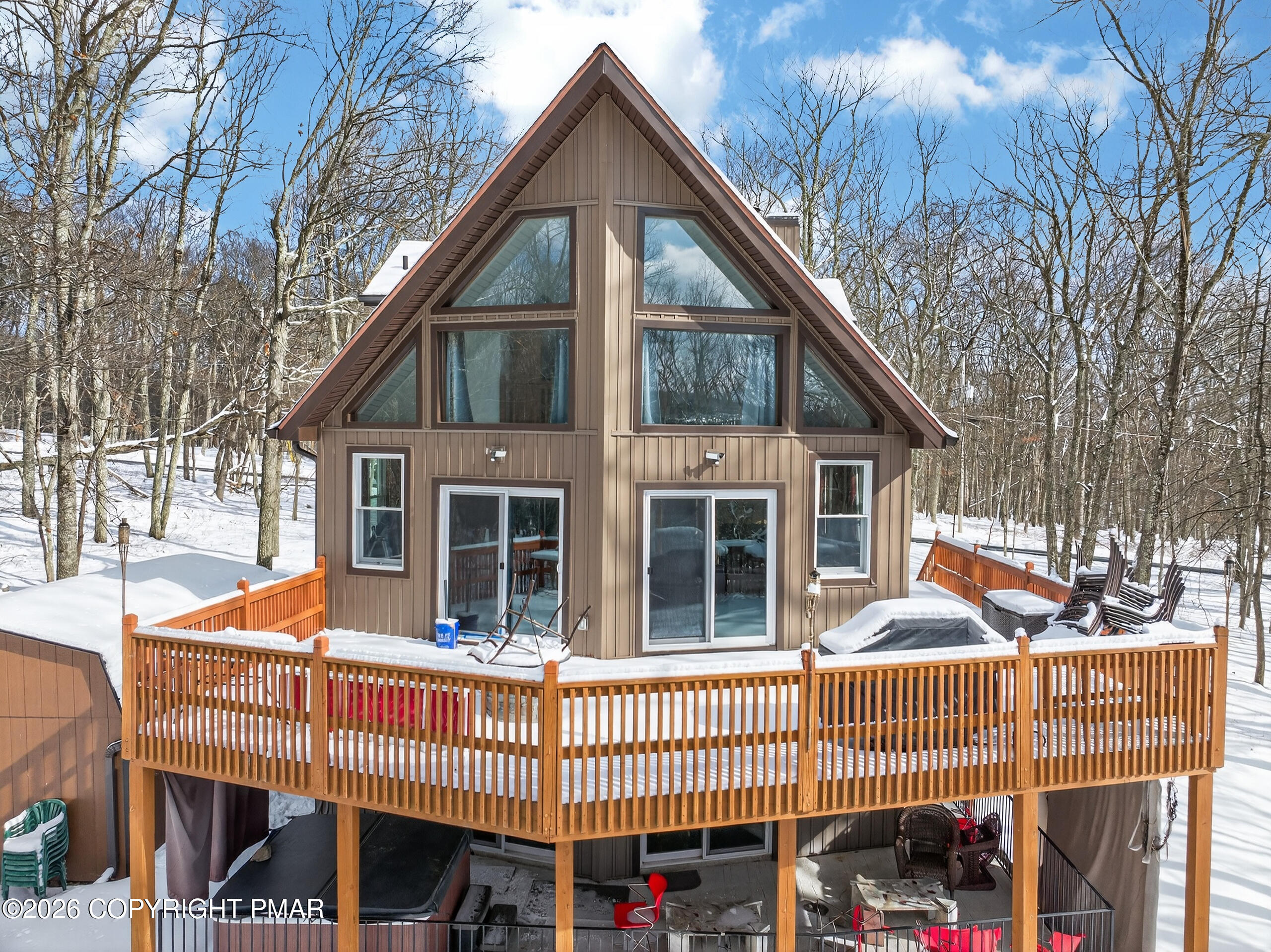 3112 Spring Court Bushkill, PA 18324 - Photo 5 of 52 a view of a house with a wooden deck and a barbeque