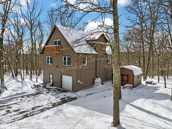 a front view of a house with parking area