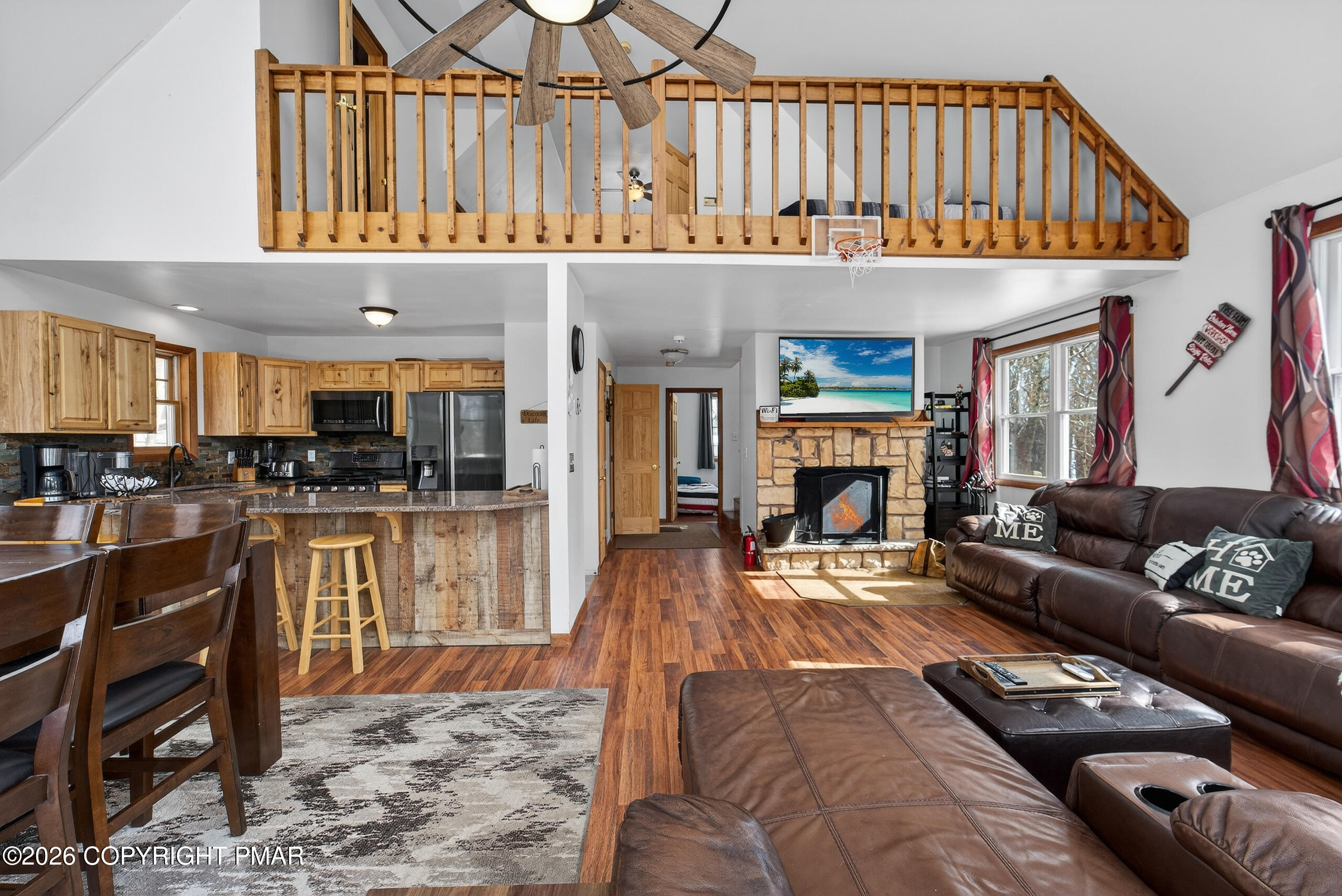 3112 Spring Court Bushkill, PA 18324 - Photo 10 of 52 a living room with furniture a fireplace and kitchen view