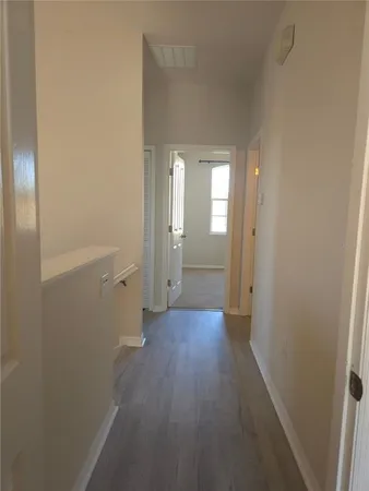 a view of a room with wooden floor