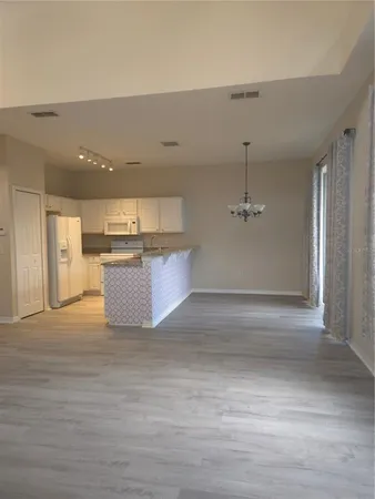a view of a kitchen with a sink and a refrigerator