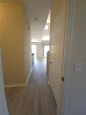 a view of a hallway with wooden floor