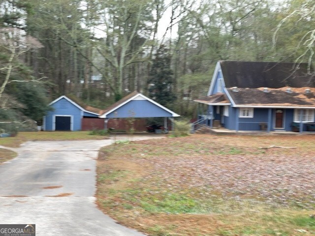 3055 Spot Road Cumming, GA 30040 - Photo 4 of 6 a front view of a house with wooden fence