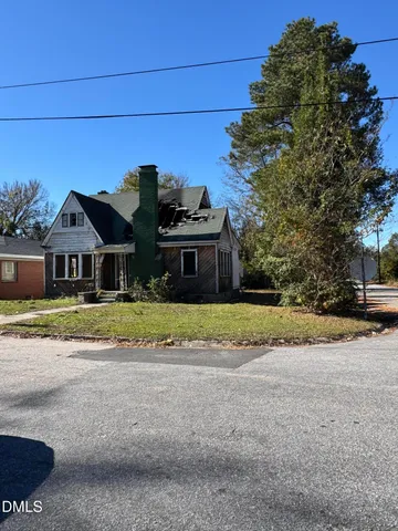 a front view of house with yard and trees