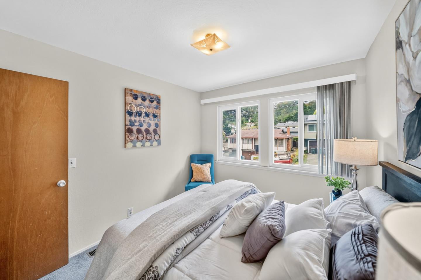 1287 Lerida Way Pacifica, CA 94044 - Photo 37 of 52 a bedroom with a bed and a painting on the wall