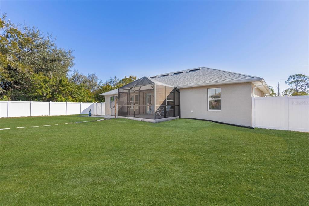 8049 Dimstead Street Port Charlotte, FL 33981 - Photo 15 of 39 a view of a house with a backyard