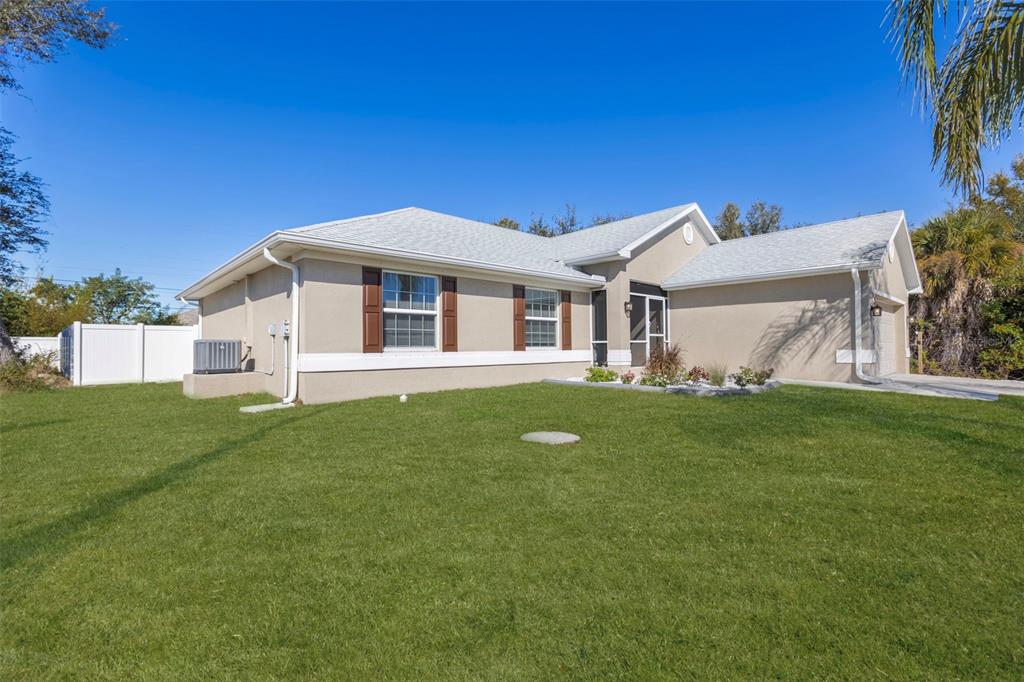 8049 Dimstead Street Port Charlotte, FL 33981 - Photo 16 of 39 a view of a house with a yard