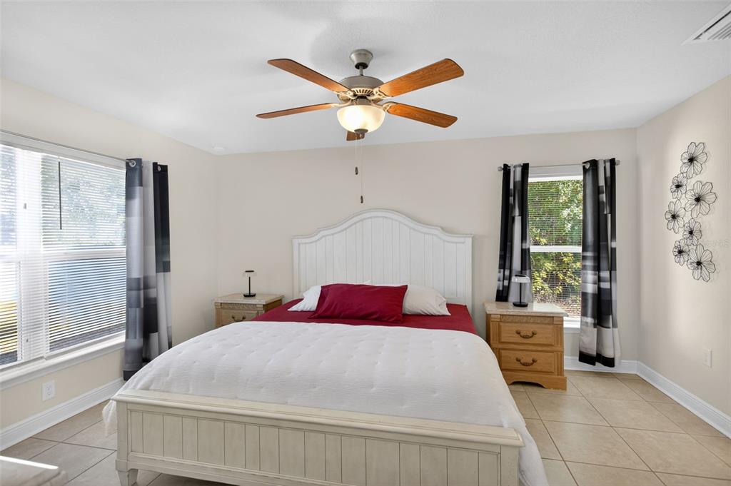 8049 Dimstead Street Port Charlotte, FL 33981 - Photo 18 of 39 a bedroom with a large bed and a window