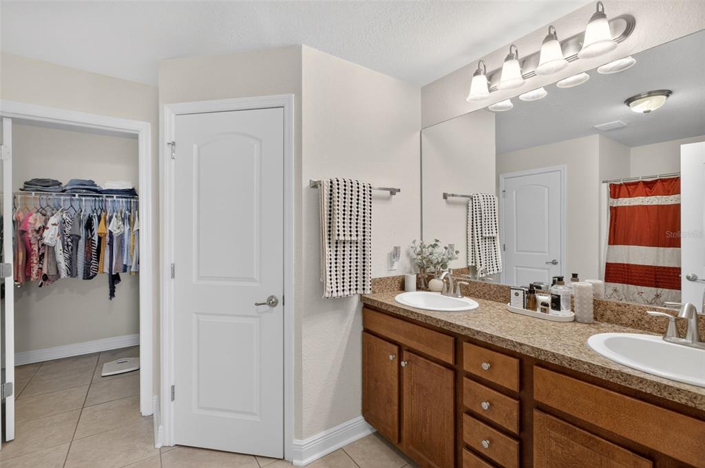 8049 Dimstead Street Port Charlotte, FL 33981 - Photo 21 of 39 a bathroom with a double vanity sink and a mirror