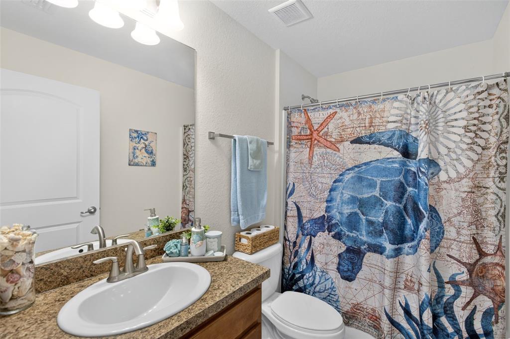 8049 Dimstead Street Port Charlotte, FL 33981 - Photo 26 of 39 a bathroom with a granite countertop toilet sink and mirror
