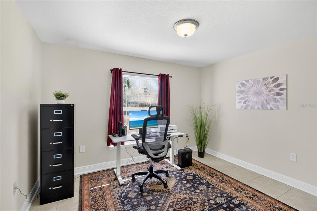 8049 Dimstead Street Port Charlotte, FL 33981 - Photo 27 of 39 a view of a workspace with furniture and a window