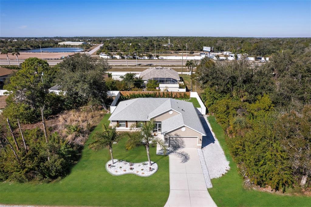 8049 Dimstead Street Port Charlotte, FL 33981 - Photo 34 of 39 an aerial view of a house with a garden and lake view